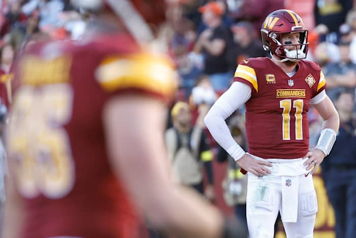 Washington Commanders quarterback Carson Wentz (11) stands on the field after throwing an interception against the Cleveland Browns during the fourth quarter at FedExField.